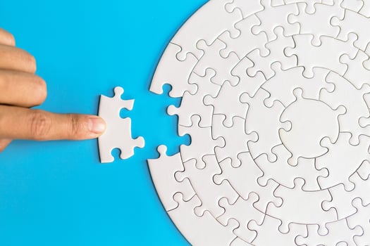 Hand put the last piece of jigsaw puzzle to complete the mission. Completing final task, missing jigsaw puzzle pieces and business concept with a puzzle piece missing. photo