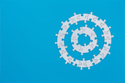 White jigsaw puzzle on blue background, Copy space. photo