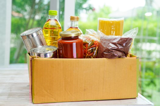 Foodstuffs in donation box for volunteer. photo