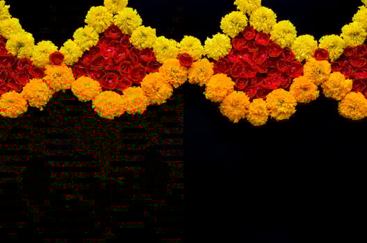 Decorative rose and marigold flowers rangoli for Diwali festival on black background. photo