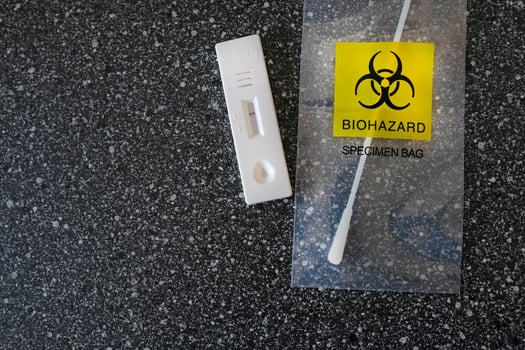 Coronavirus - COVID-19 - rapid test with negative result next to a nasal swab in a transparent bag with bio hazard photo