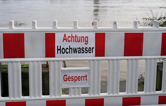 Extreme weather - Warning sign in German at the entrance to a flooded pedestrian zone in Cologne, Germany photo