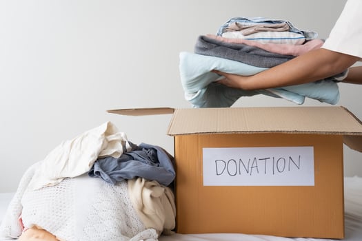 Clothing donation, Sharing, Hope concept. Used clothes on the carton donation box preparing to others photo