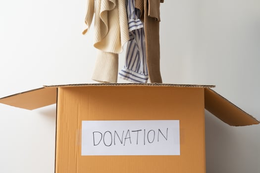 Concept of cloth donation. Putting old and un-use second hand shirt sending out for donation. photo