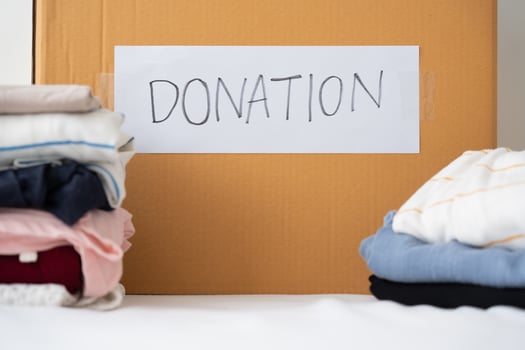 Clothing donation, Sharing, Hope concept. Used clothes on the carton donation box preparing to others photo