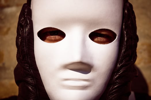 Close up of person with white mask over the face. photo