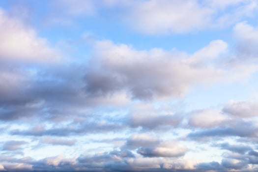 low fluffy gray clouds in blue sky in twilight photo