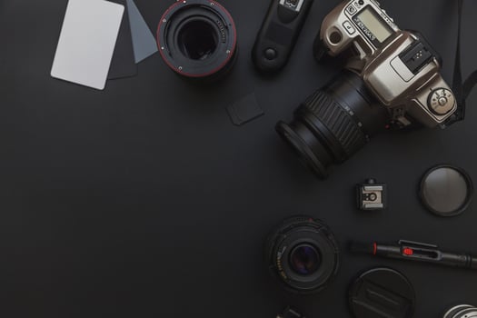 Photographer work place with dslr camera system, camera cleaning kit, lens and camera accessory on dark black table background. Hobby travel photography concept. Flat lay top view copy space. photo