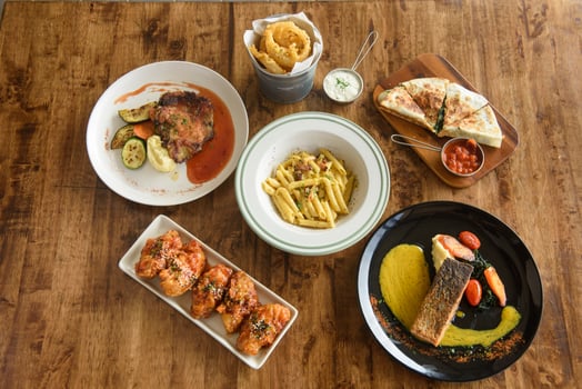 Different appetizer and anti pasti on wood background photo