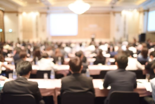 Abstract blurred people in big meeting or conference room for background. vintage tone photo
