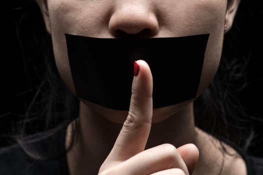 Woman with her hand extended signaling to stop photo