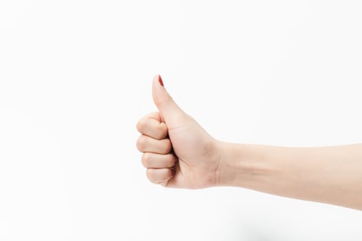 A woman hand in like symbol gesture on a white background photo