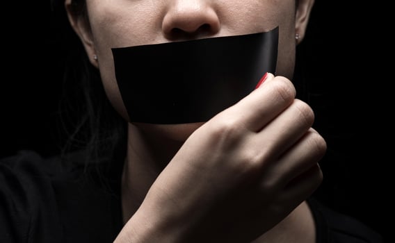 The girl's face is sealed her mouth with black paper Premium Photo