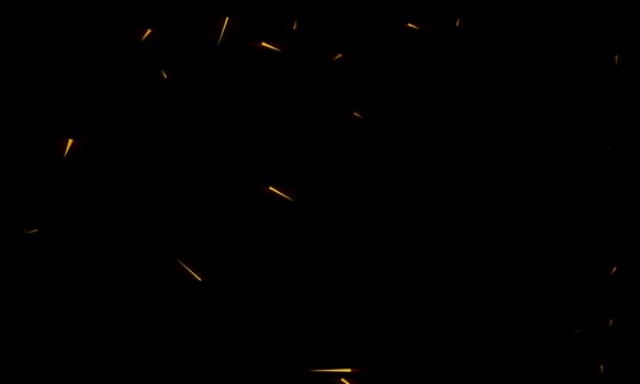 Burning red hot sparks fly from large fire in the night sky. Beautiful abstract background on the theme of fire, light and life. photo