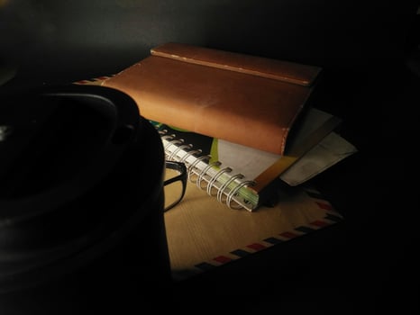 brown cover book on black background. painting light.close up. photo