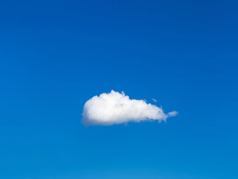 solitary white cloud in blue sky photo