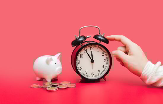 woman hand putting money coin into piggy photo