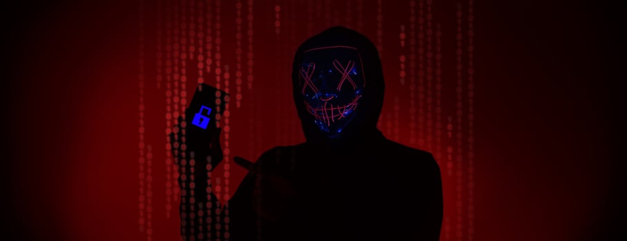 Digital security Concept. Anonymous hacker with mask holding smartphone hacked. photo