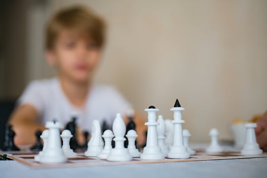 Boy playing chess board. photo