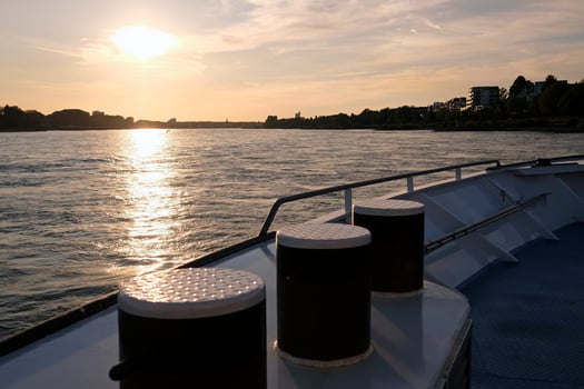 Sunset over water seen from a boat on the Rhine river near Cologne, Germany photo