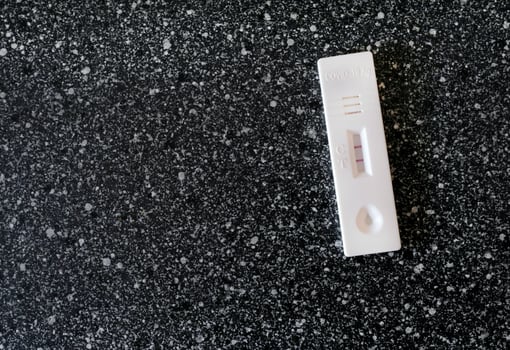 Coronavirus - COVID-19 - rapid test with positive result on a table photo
