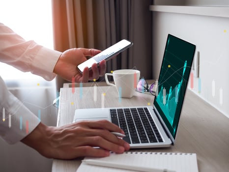 Data analyst using laptop and smartphone to analysis of a big data, data analysis and financial network strategy. photo
