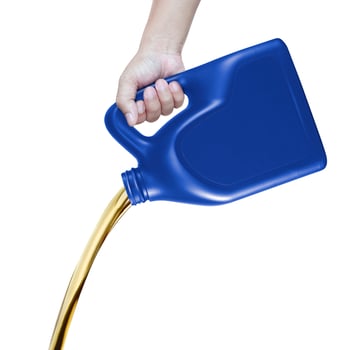 pour car motor lubricant from blue bottle on isolated white background photo