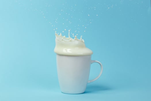 Milk splashing from the cup photo