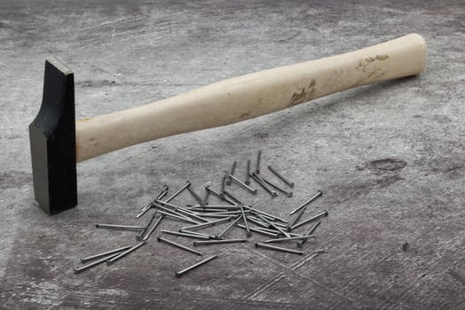 Hammer and nails isolated on stone background photo