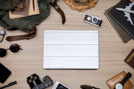 Top view mockup of Traveler's accessories with passport, books of travel plan, wallet, camera, hat, backpack and airplane toy on brown wooden desk empty space, Travel concept background photo