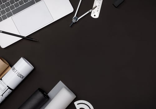 Creative flat lay of architects black table with roll blueprints, architectural project plan, engineering tools, office supplies and laptop computer, Workspace for new designer concept photo