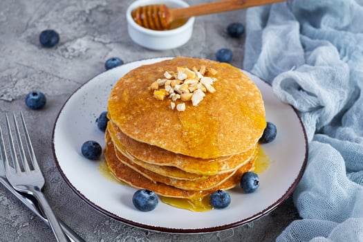 Delicious homemade pancakes with honey and blueberries. Tasty breakfast with crepes photo