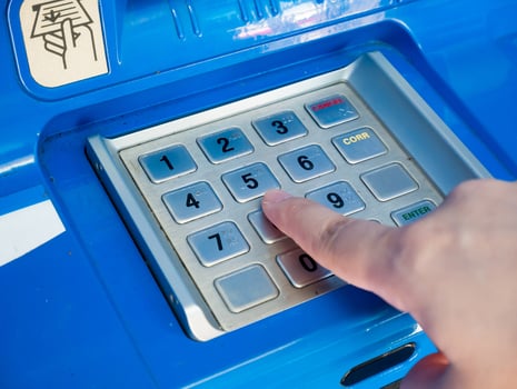 woman using ATM machine to withdraw money photo