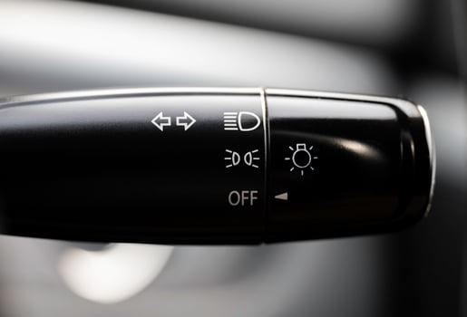 Turn signal lever, adjusting car headlight control switch. photo