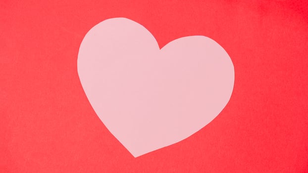 Shape of heart on red paper background. photo