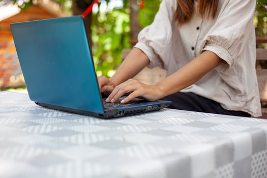 Hands of a woman pressing a notebook computer keyboard to do some work or search for information. photo