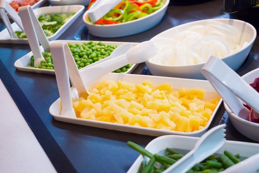 fresh vegetables on salad bar buffet shelves in restaurant photo