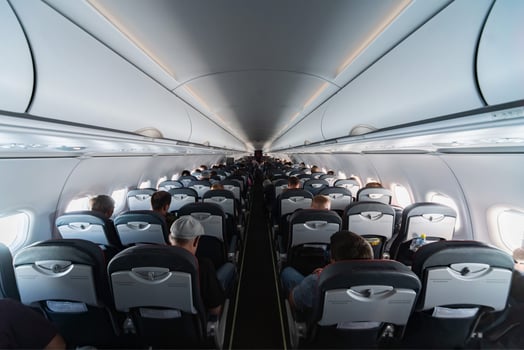 Airplane cabin seats with passengers. Economy class of new cheapest low-cost airlines without delay or cancellation of flight. Travel trip to another country. photo