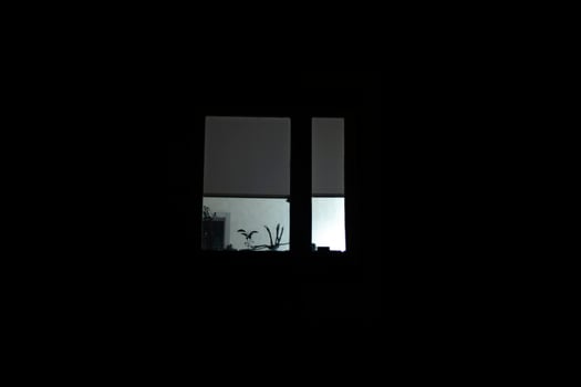 Window is in dark. Window light at night. Details of building in total darkness. photo