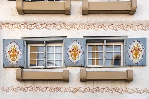 Old wooden window with blinds and curtains. Scenic original and colorful view of antique windows in the old city in Germany. No people. Front view. Old fashioned style. photo