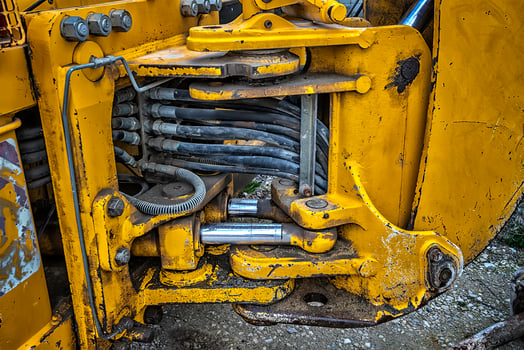 Detail of modern yellow excavator machines. Close up photo