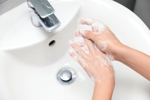 Woman use soap and washing hands under the water tap. photo