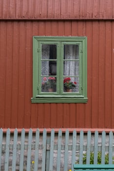Oslo, Norway. May 29, 2022. Green window frame on a red house at The Norwegian Museum of Cultural History in Oslo. photo