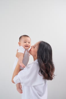 happy family mother playing and hug with baby daughter photo