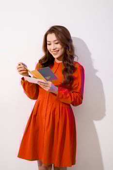 Young happy beautiful woman is reading postcard. photo