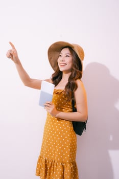 Woman traveler with passport and ticket on white background photo