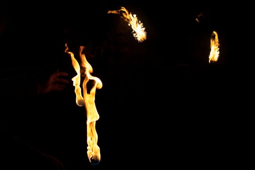 Flames in dark. Burning kerosene. Fire show at festival. photo
