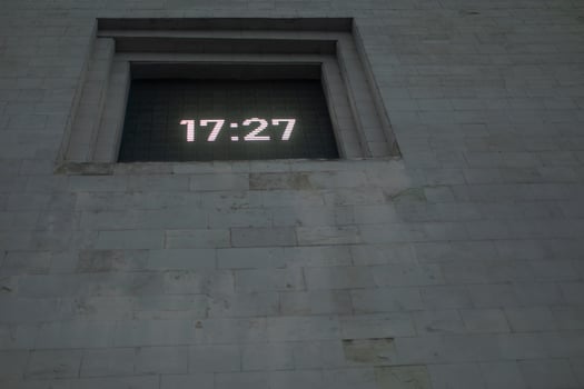 Time on clock board. Clock in wall. Time from electronic digits. photo
