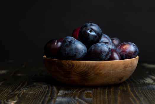 Ripe plums on the table in the kitchen photo