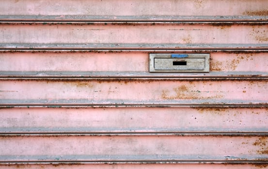 Letterbox on a weathered metal door photo
